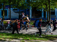 A group of climate activists are running to their way of the blockade in Zuidas, the financial heart district of Amsterdam during the Extinc...