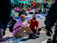 Some climate activists blocked the main road of the financial district by glued themselves during an act of peaceful civil disobedience. Wit...