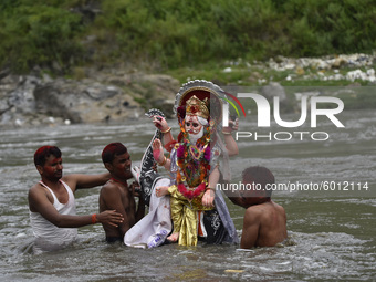 Nepalese Devotees immerse the idol of lord Vishwakarma in the Bagmati river at Kathmandu, Nepal Friday, September 18, 2020. Vishwakarma is t...