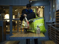 A fast food delivery man packs food to deliver on September 18, 2020 in Warsaw, Poland. (