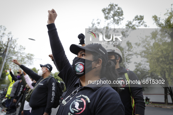 A member of a rescue group raises her fist outside where the Alvaro Obregon 286 building was located on September 19, 2020, in Mexico City,...