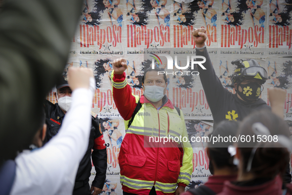 Members of a rescue group raise their fist outside where the Alvaro Obregon 286 building was located on September 19, 2020, in Mexico City,...