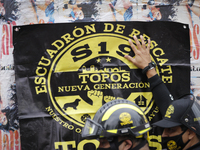 Members of the rescue group Topos place a sign outside where the Alvaro Obregon 286 building was located on September 19, 2020, in Mexico Ci...