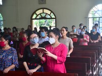Christian worshiper sing s hymn wearing protective face mask inside a church as they attend a Sunday service amid Covid-19 at Mao Baptist Ch...