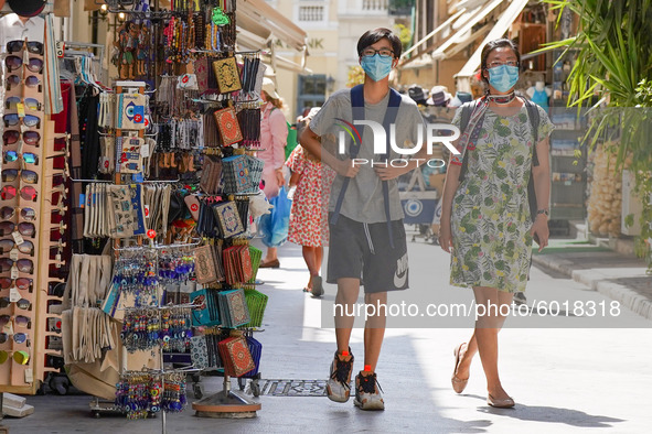 Tourists wearing face coverings walk in Central Athens amid the second wave of the pandemic in Athens, 20 September 2020. 
