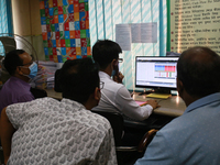 Investors look at the screens during trading hours in a brokerage house in Dhaka, Bangladesh on September 20, 2020. (