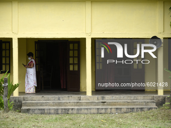 A teacher arrives  at a school, in Guwahati, Assam, India on September 21, 2020 as schools reopened after more than 5-months closure due to...