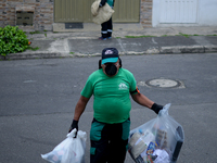 Mr. Botache belongs to the group of Environmental Recuperators walks through the streets of the town of San Cristobal on a collection day in...
