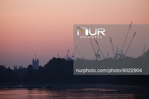 The Victoria Tower of the Houses of Parliament, and the cranes of a construction site in the Victoria neighbourhood of the City of Westminst...