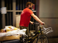 Taron has finished for this night and came back to his apartment with his bicycle full of products.Tarin, a young man, searches for food in...