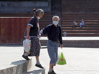 An elderly couple wearing protective face masks amid the COVID-19 coronavirus epidemic is seen in Kyiv, Ukraine on 23 September 2020.  (