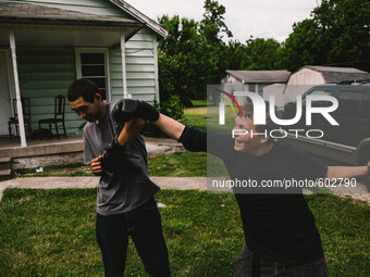 Friends Braydon (left) and Mark (right) are seen play boxing in the front yard of Braydon's home in Austin,Indiana May,22,2015.   