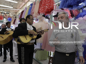 Mariachis walk the aisles of the Mixcalco Market to celebrate the 63rd anniversary of the La Merced and Jamaica Markets, which were founded...