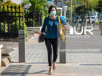 A worker walking at Sudirman Street, South Jakarta despite the restriction to enter office during partial lockdown, on 24 September 2020. Ja...