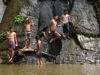 A Naga youth jump into the water to cool off beside a small stream on a hot summer day in the outskirt of Dimapur, India north eastern state...