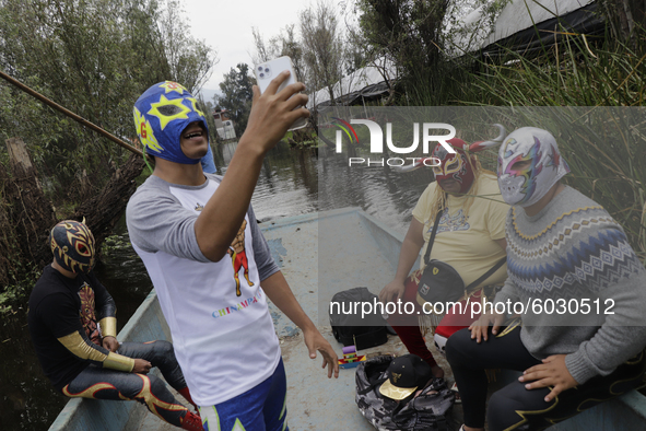 Members of Chinampaluchas aboard a boat, prior to the wrestling function in chinampas of Lake Xochimilco during the health emergency due to...
