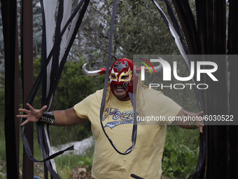 Mr. Jerry, a member of Chinampaluchas, during a wrestling function in the chinampa of Lake Xochimilco during the health emergency due to COV...
