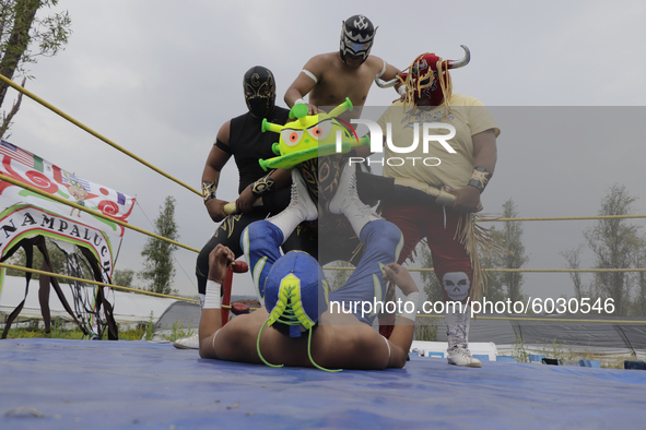 Members of Chinampaluchas, during a wrestling function, fight against the coronavirus in chinampa on Lake Xochimilco during the health emerg...