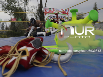 Mr. Jerry mask and coronavirus hat, belonging to members of Chinampaluchas, during wrestling function in Chinampa of Lake Xochimilco during...