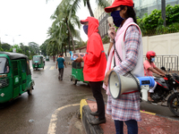 Volunteer of Bangladesh Red Crescent Society aware to Pedestrians for using facemask during the Covid-19 Coronavirus pandemic in Dhaka, Bang...