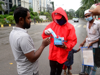 Volunteer of Bangladesh Red Crescent Society distribution facemak to Pedestrians for using during the Covid-19 Coronavirus pandemic in Dhaka...