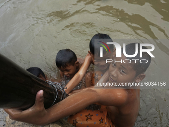Children in Sungsang, Banyuasin Regency, South Sumatra are enjoying swimming in the sea in front of their house in Sungsang District, Banyua...