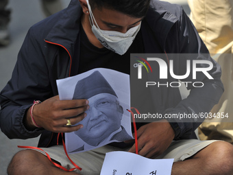 Nepalese youth as they arrive along with a printed portrait mask of Prime Minister KP Sharma Oli during a demonstration expressing Solidarit...