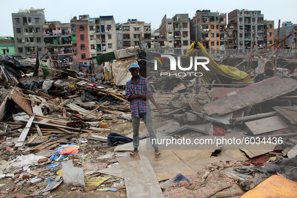 A boy at the site of demolished slum dwellings after demolition drive by the Delhi Development Authority (DDA) against encroachments at Jami...