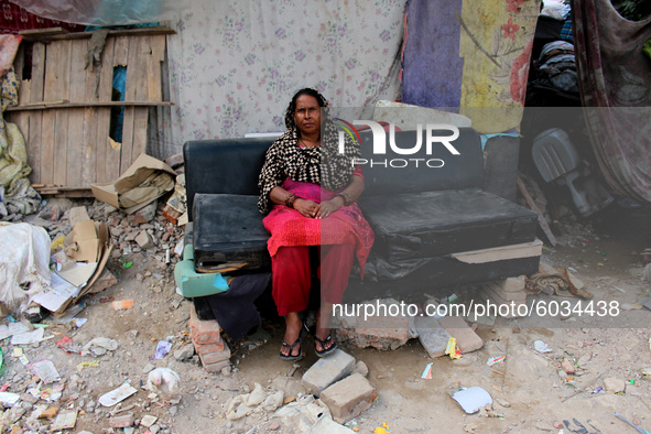 A woman is seen outside her demolished slum dwelling after demolition drive by the Delhi Development Authority (DDA) against encroachments a...