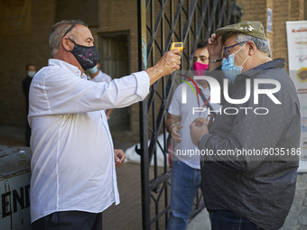 An operator of the bullring, takes the temperature of an assistant at the entrance prior the Virgen de las Angustias Bullfighting Festival a...