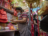 A store owner is seen fixing up a lantern on September 26, 2020 in Hong Kong, China. Mid-Autumn Festival also known as the Lantern Festival...