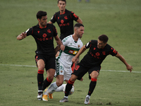 Tete Morente of Elche and Mikel Merino and Andoni Gorosabel of Real Sociedad compete for the ball during the La Liga Santader match between...