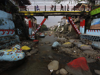 People are seen crossing over the a bridge at the Ciliwung river in Bogor, West Java, 27 September 2020. World Rivers Day (WORD) is celebrat...