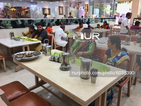 People eat a traditional vegetarian meal at an upscale South Indian restaurant in Nagercoil, Tamil Nadu, India on February 12, 2020. 