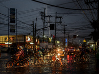 Cyclists wade through a flooded road in Malabon, Philippines on September 29, 2020.(