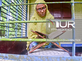 A village Muslim woman reads the Al Quran at morning in her home in Jamalpur District, Bangladesh, on October 01, 2020 (