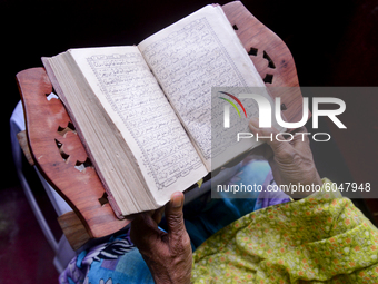 A village Muslim woman reads the Al Quran at morning in her home in Jamalpur District, Bangladesh, on October 01, 2020 (