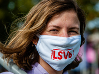 A woman is wearing a mouth mask with the logo of one of the student syndicates, during the students protest for more physical attendance cla...