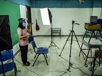 A teacher makes use of green screen in filming lectures in preparation for the opening of classes at a school in Valenzuela City in Metro Ma...