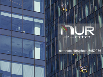 Window cleaners seen in Warsaw on September 28, 2020. (
