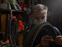 The work of small and medium artisans during the coronavirus emergency, in their small shops.
In the photo a bicycle maker , in Rieti, Italy...