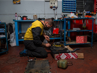 The work of small and medium artisans during the coronavirus emergency, in their small shops. In the photo a mechanic , in Rieti, Italy, on...
