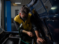 The work of small and medium artisans during the coronavirus emergency, in their small shops. In the photo a mechanic , in Rieti, Italy, on...