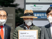 Lee Rae-jin(center), a brother of a South Korean civil servant who died after being shot by North Korean soldiers, visits the United Nations...