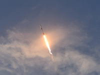 As seen from Canaveral National Seashore, a SpaceX Falcon 9 rocket carrying 60 Starlink satellites launches from pad 39A at the Kennedy Spac...