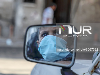 A child mask-clad due to the Covid-19 coronavirus pandemic, is reflected in a mirror at a street in Gaza city,on October 8, 2020.
 (