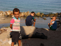 Palestinian children are seen next to Gaza beach in Al Shataa refugee camp in Gaza City, on October 8, 2020, amid the ongoing pandemic of th...
