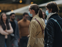 People wearing protective masks seen walking in Vitosha Boulevard, the main commercial street in the centre of Sofia. 
The number of people...