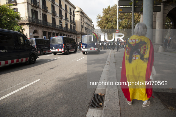 A woman with a Spanish flag that has been sprayed out when entering to provoke the pro-independence protesters in Barcelona, Spain, on Octob...