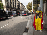 A woman with a Spanish flag that has been sprayed out when entering to provoke the pro-independence protesters in Barcelona, Spain, on Octob...
